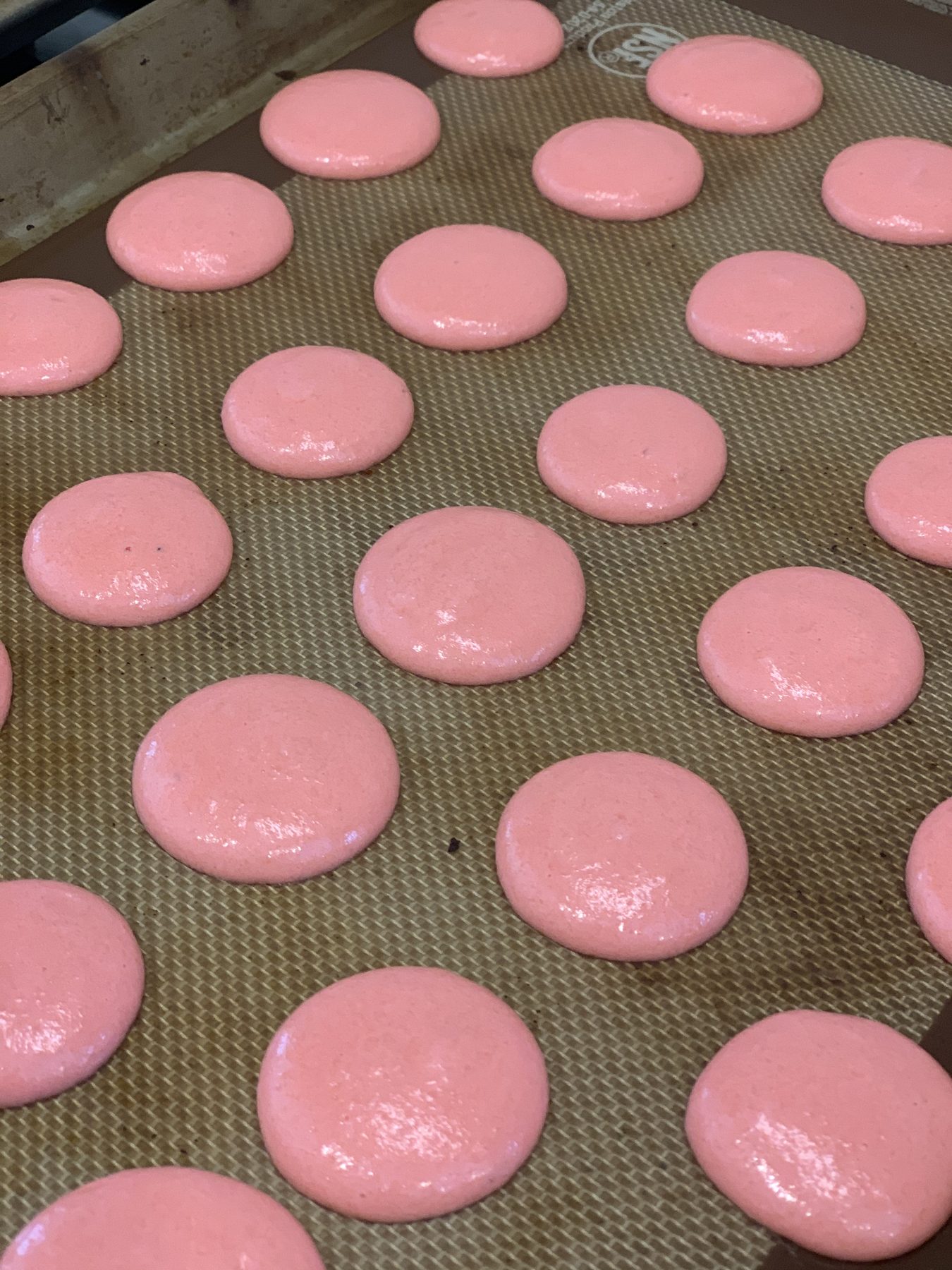 A tray of pink macarons