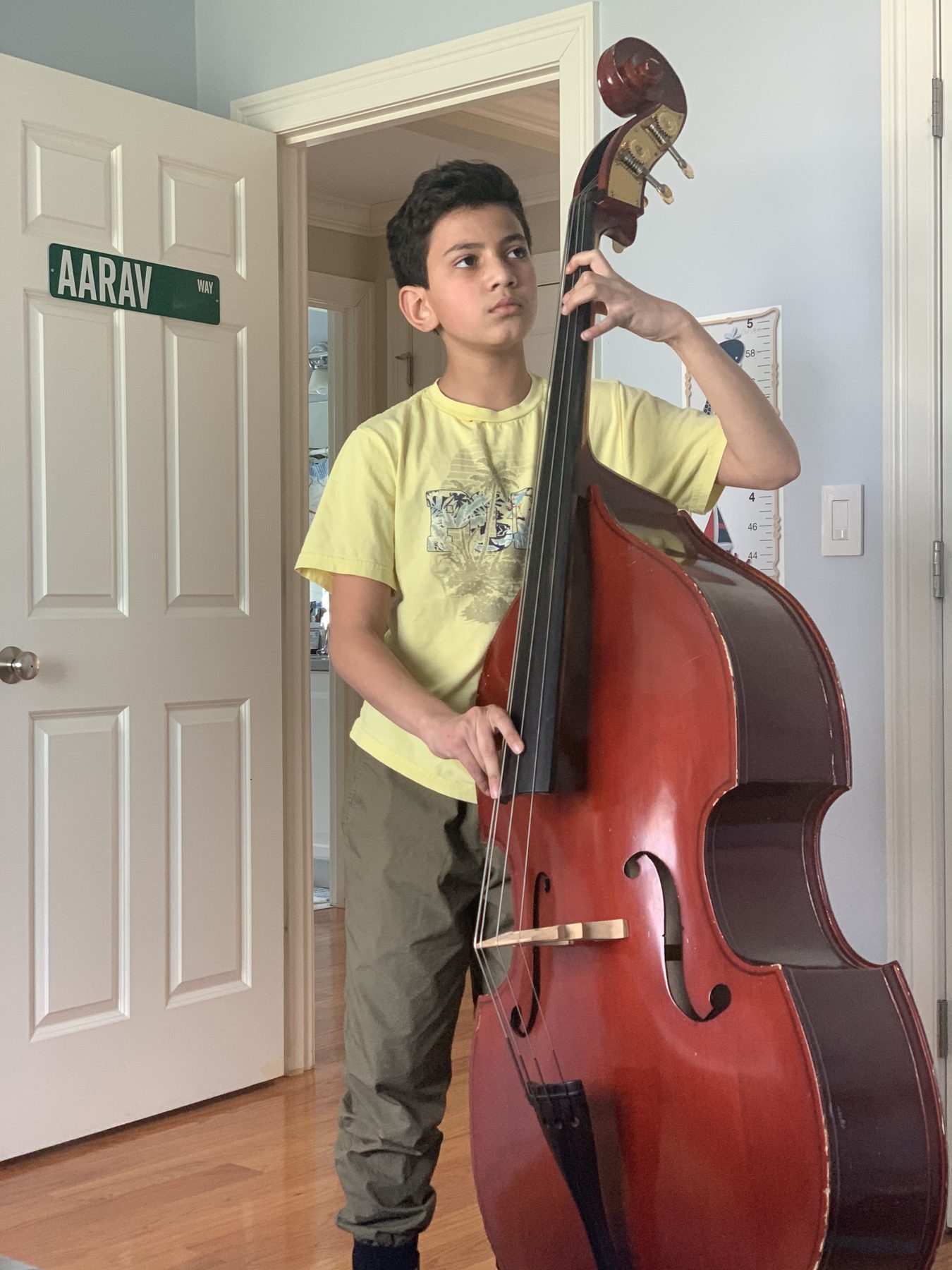 A young me practicing upright bass at home