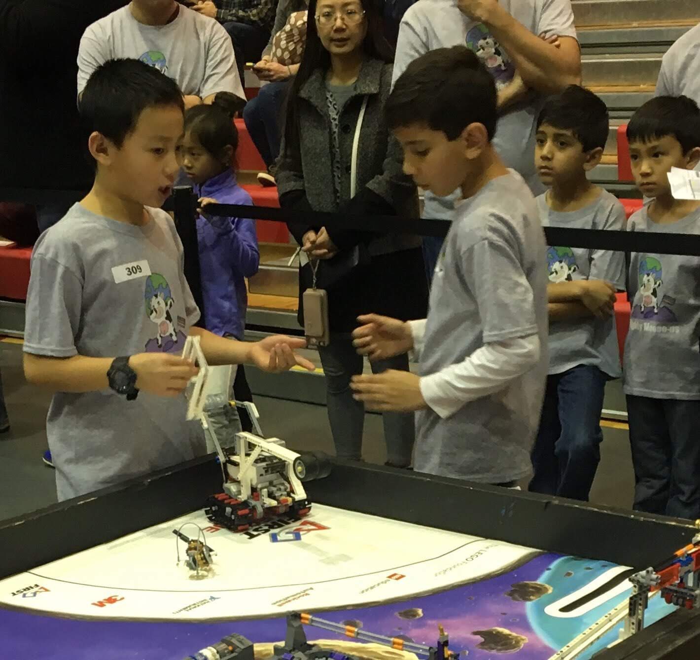 Two teammates working on the robot together