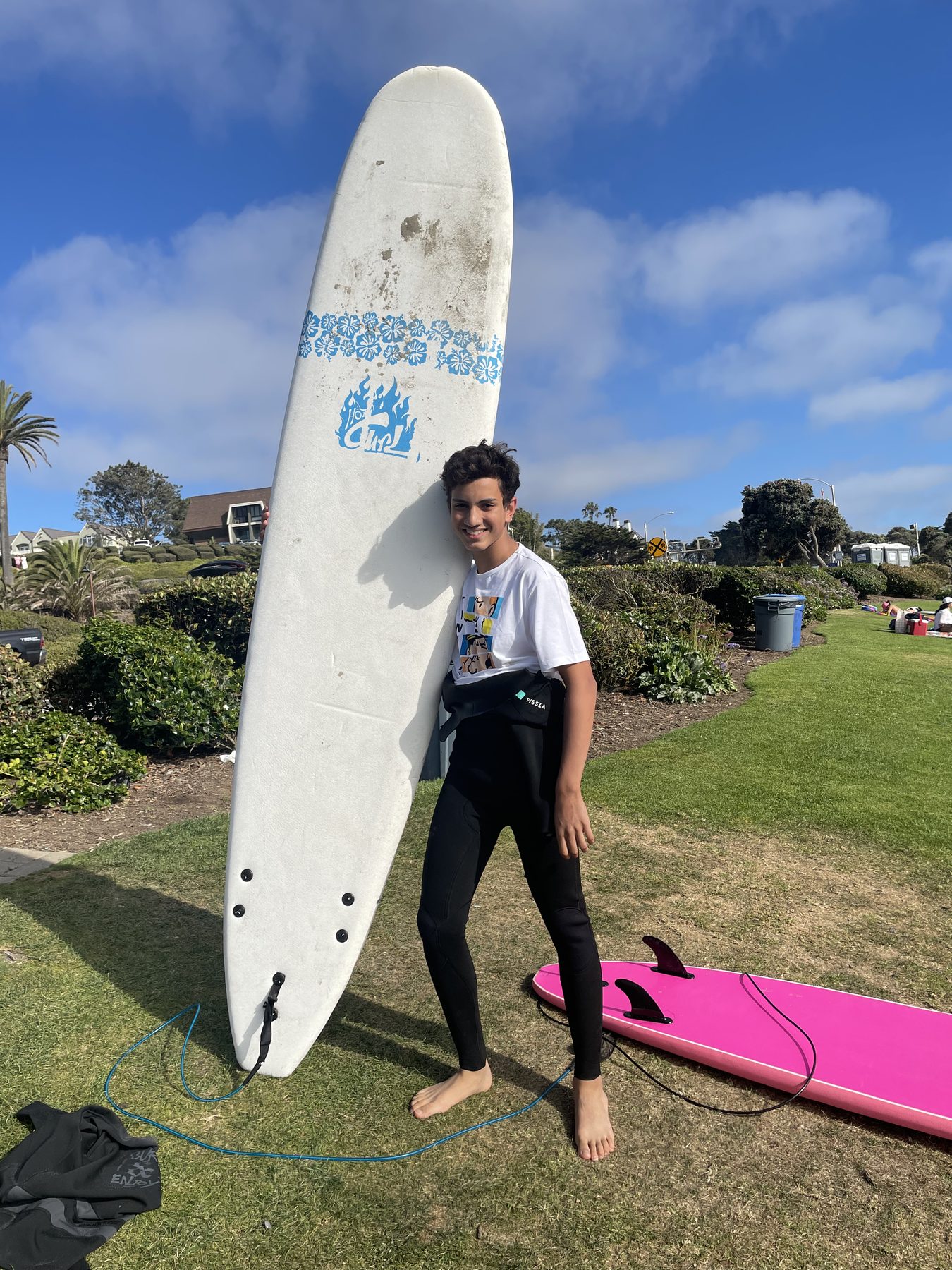 Me holding a surfboard on a beach